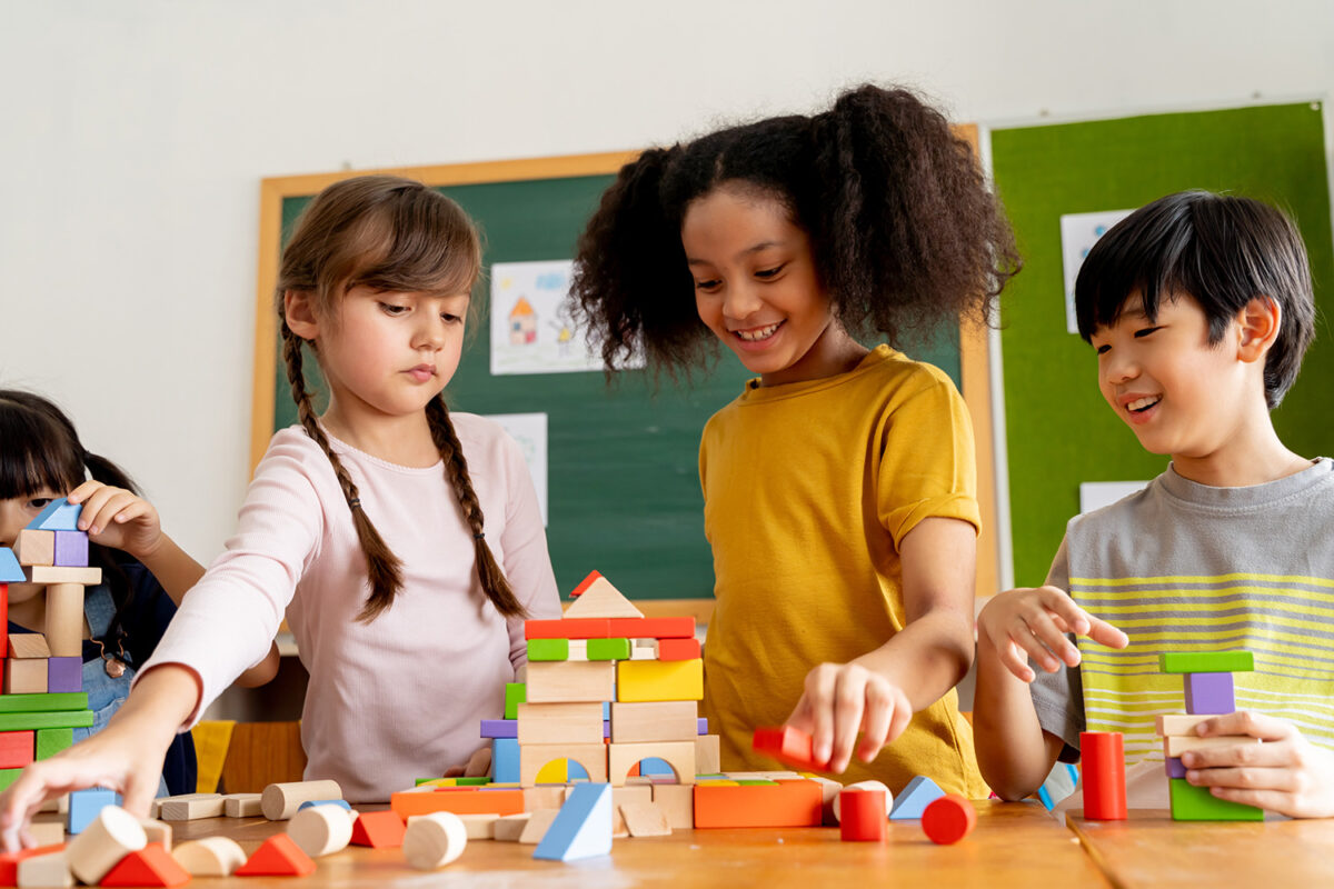 Kids playing with blocks in a classroom.